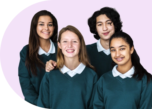 Four students standing together and smiling.