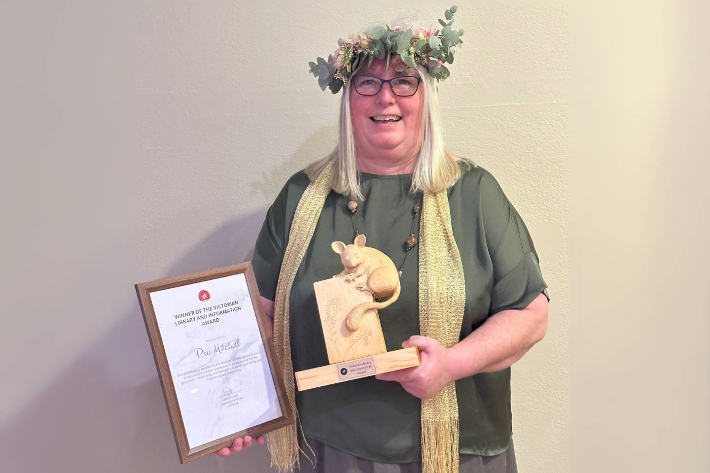 ACER's Pru Mitchell receives her award, dressed for Children's Book Week in a May Gibbs-inspired outfit.