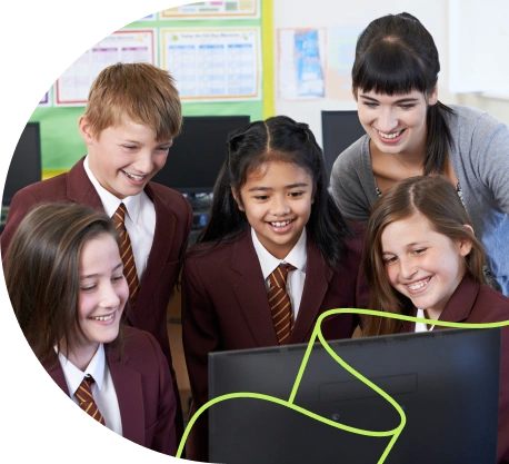 Students with a teacher looking at work on a computer