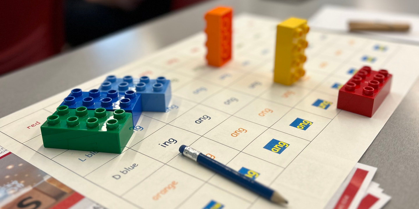 Six LEGO Duplo blocks placed on a matrix of word suffixes including 'ing' and 'ang'. Activity mat ©Amy Pritchard