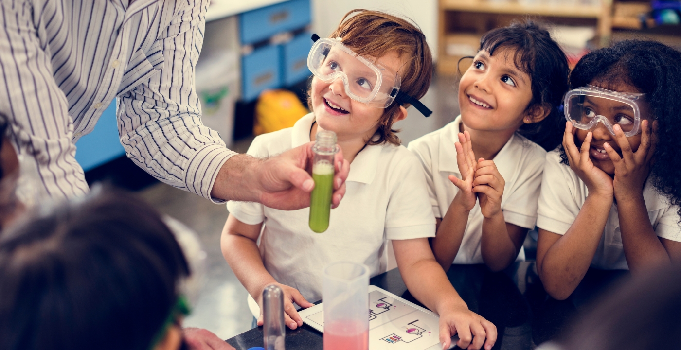 Stock photo of young children conducting a science experiment.