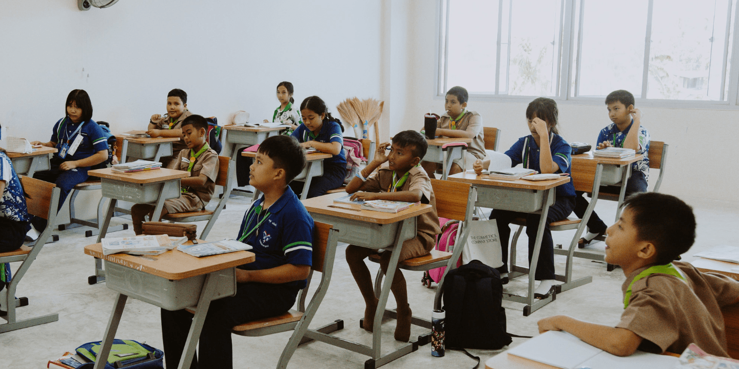 Students looking at front of classroom in Asia