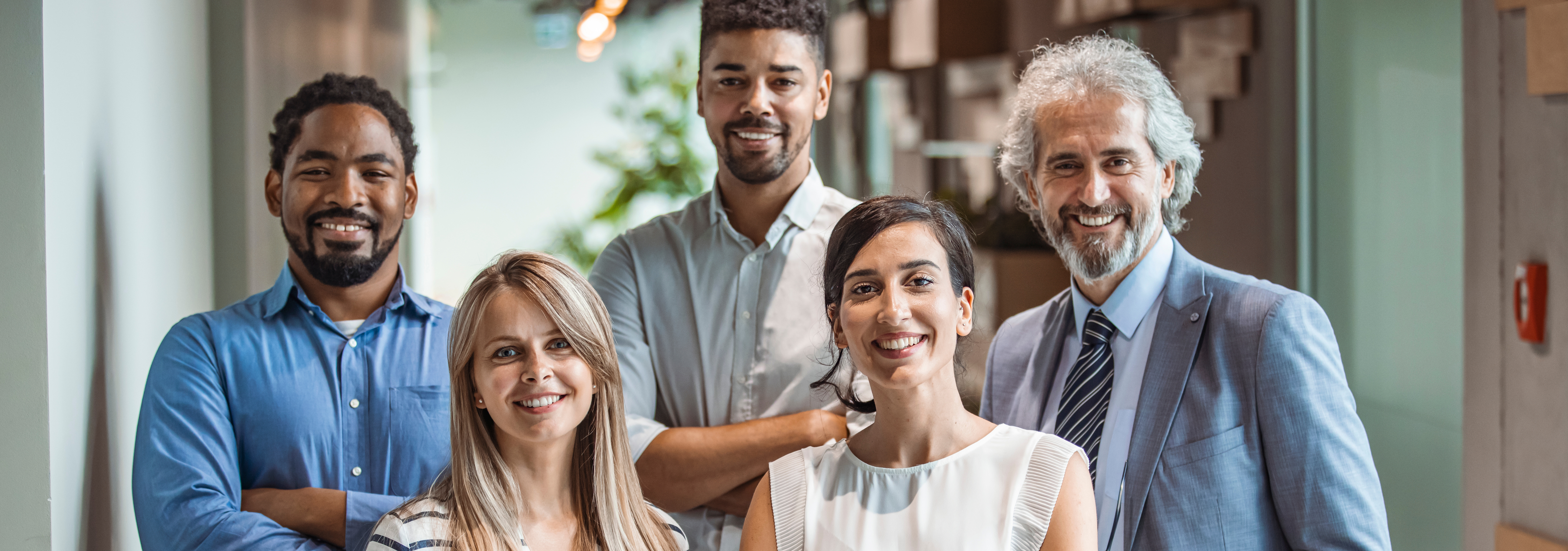 Group of business casual people sitting and leaning around a meeting table