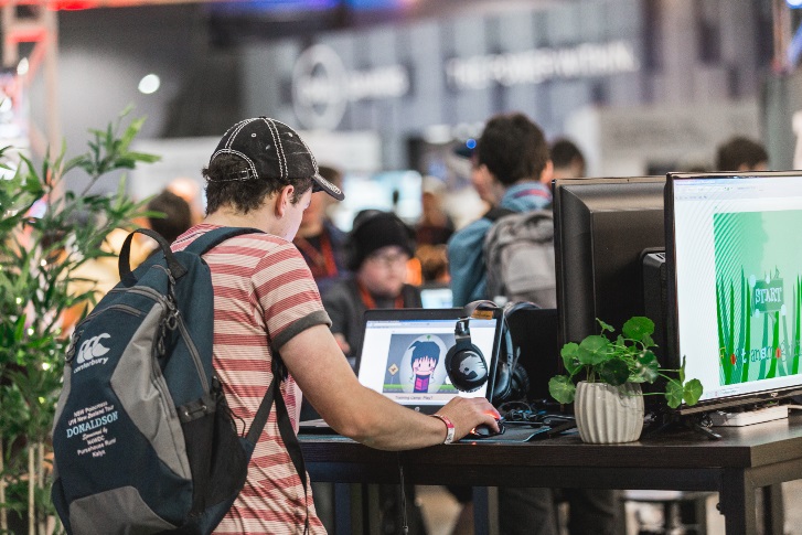 Attendee playing games on a laptop at the STEMGAMES stand at PAX 2018, Melbourne, Australia