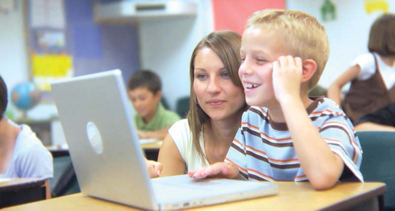Smiling young student and teacher with laptop