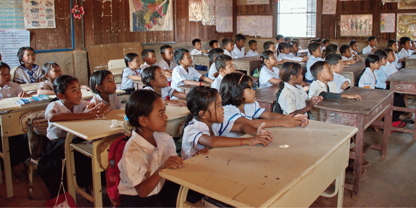 Stock image of primary school children looking towards front of class in Tonle Sap, Cambodia.