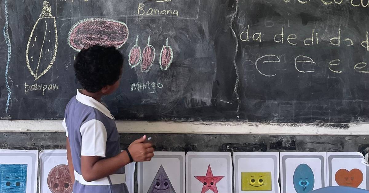 Young student writes on the board in Fiji